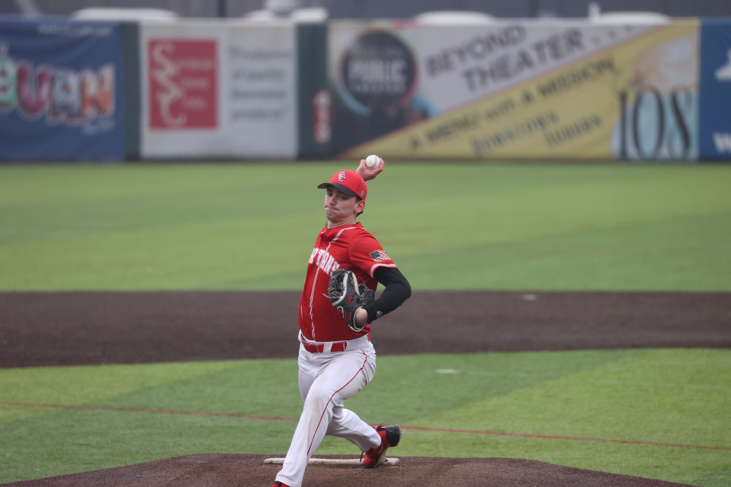 A Cayuga player throws a pitch.