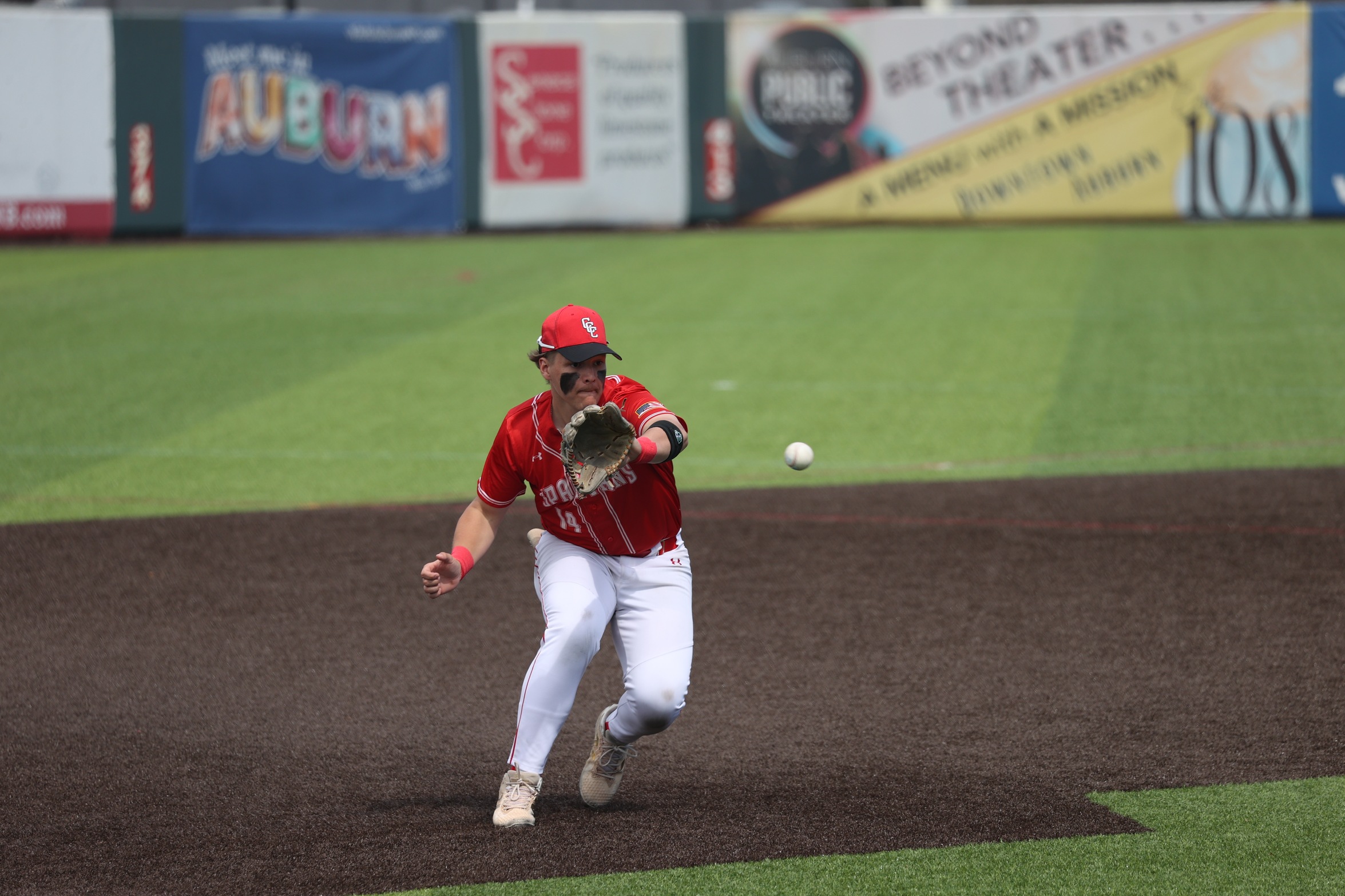 A Cayuga player fields a ground ball.