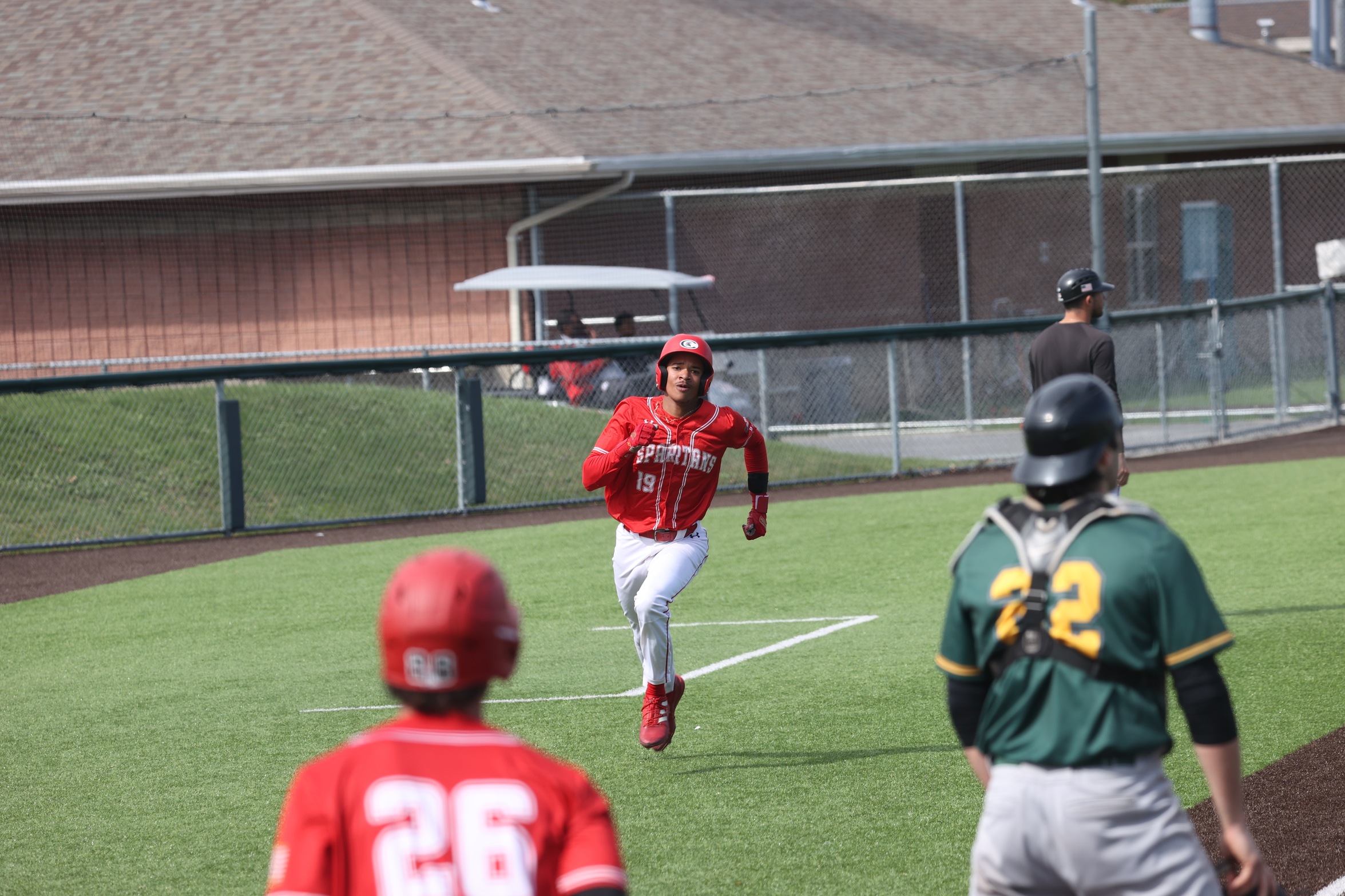 A Cayuga player runs toward home plate.