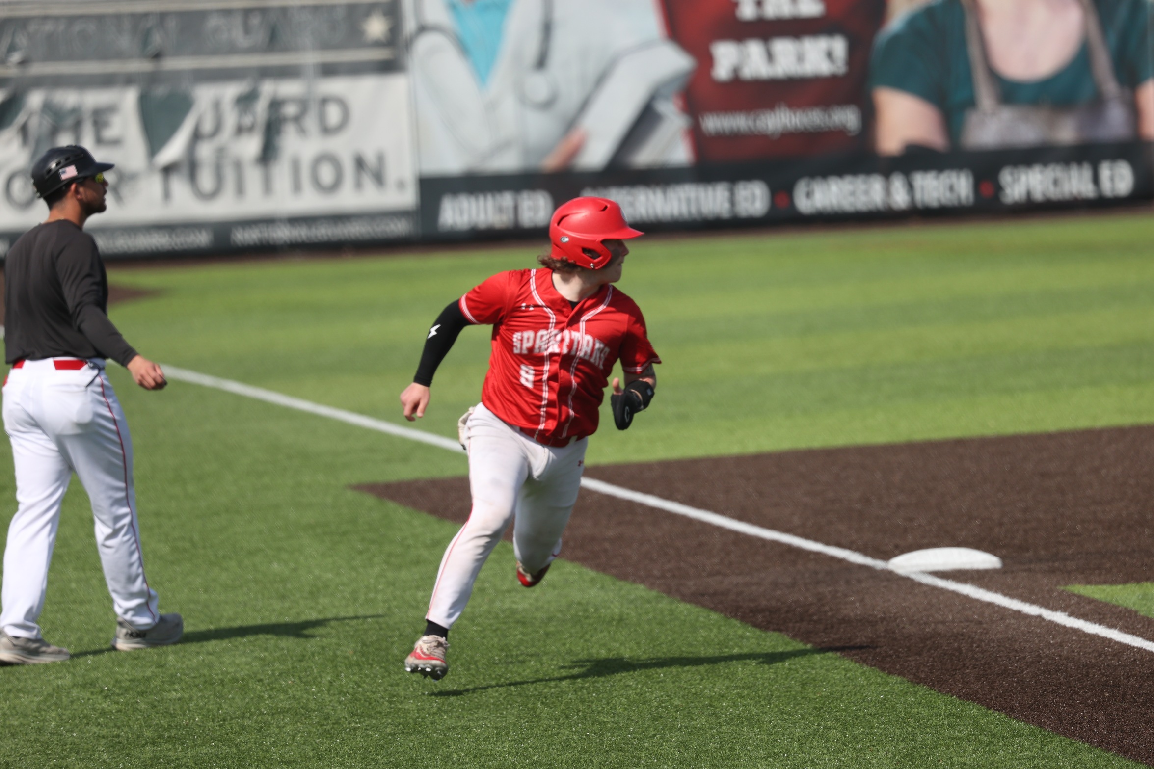 A Cayuga baserunner runs toward home.