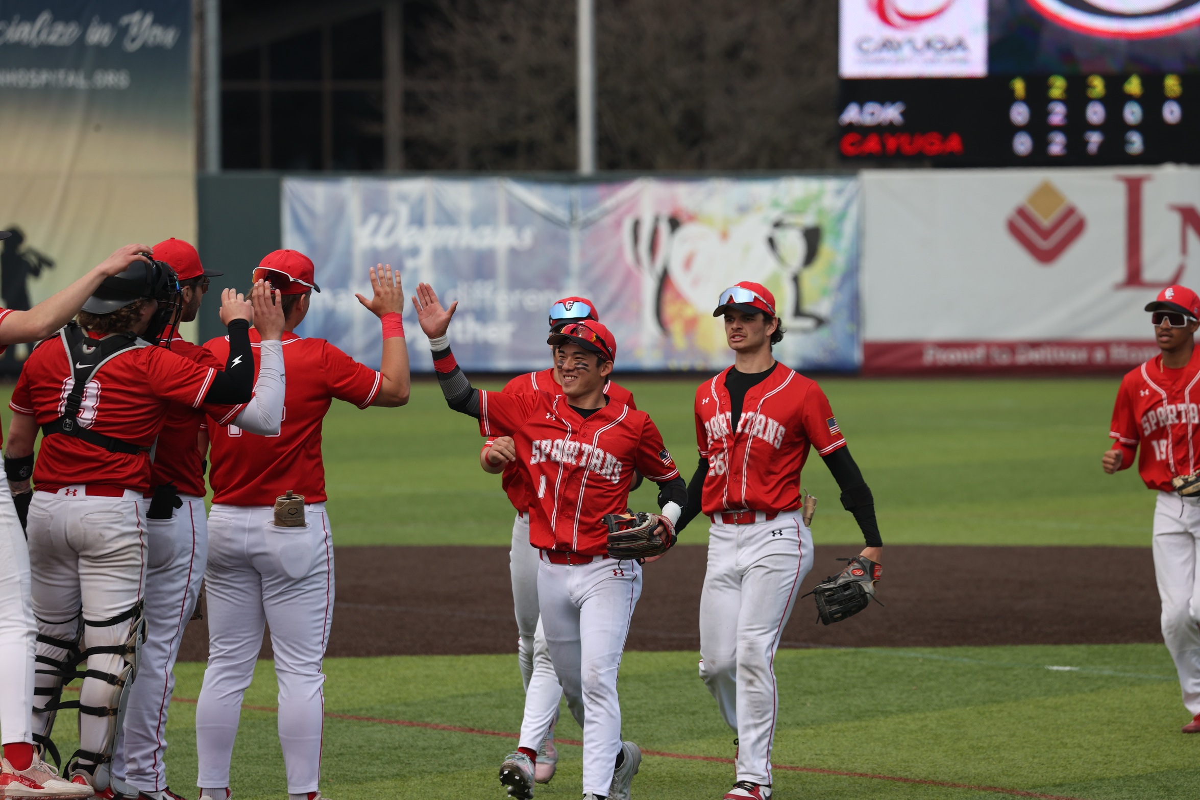 Cayuga players celebrate after a win.